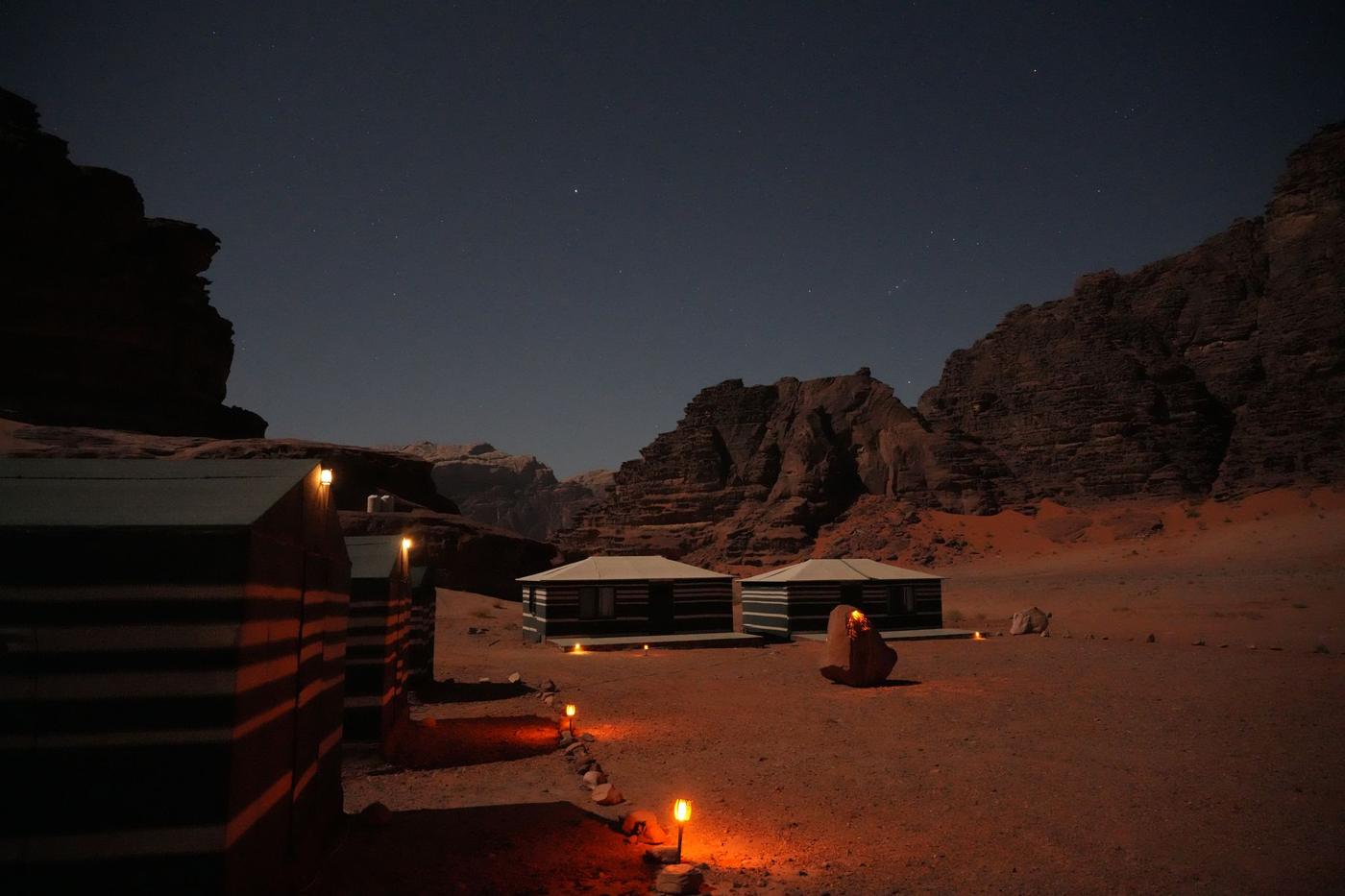 Star Beds camp at night under a starry sky in the Um Rashid canyon