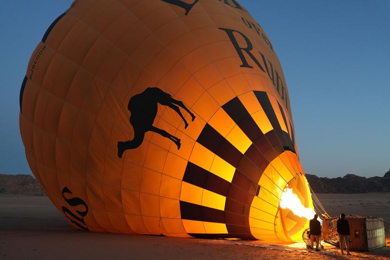 Hot air balloon being inflated at dawn in Wadi Rum